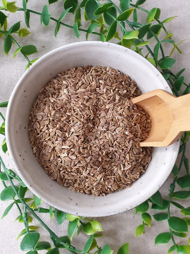 Dill Seeds in a bowl with wooden scoop
