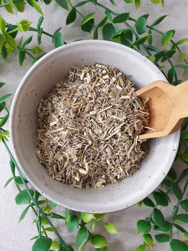 Wormwood in a bowl with wooden scoop